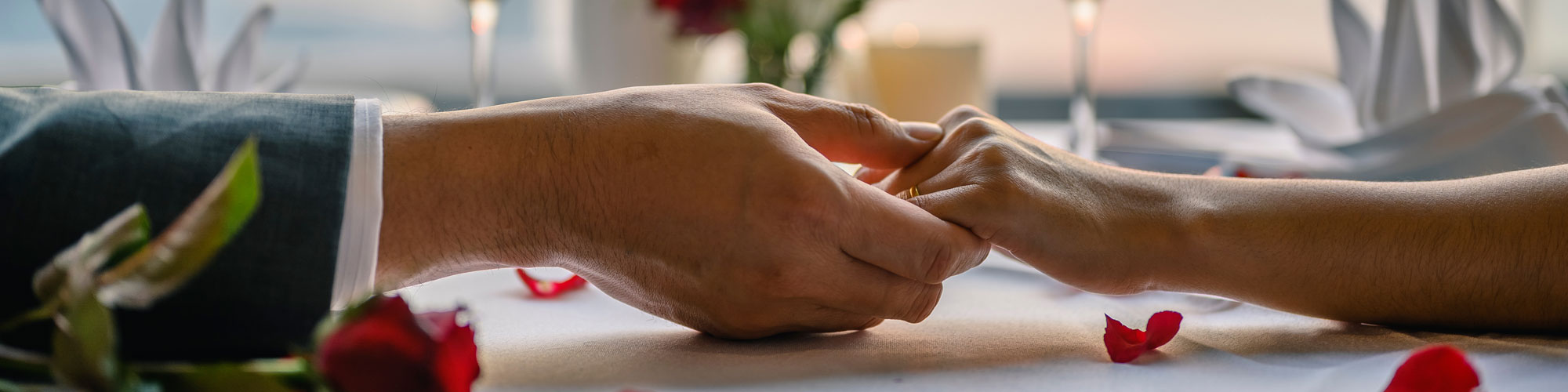 Couple Holding Hands At Table